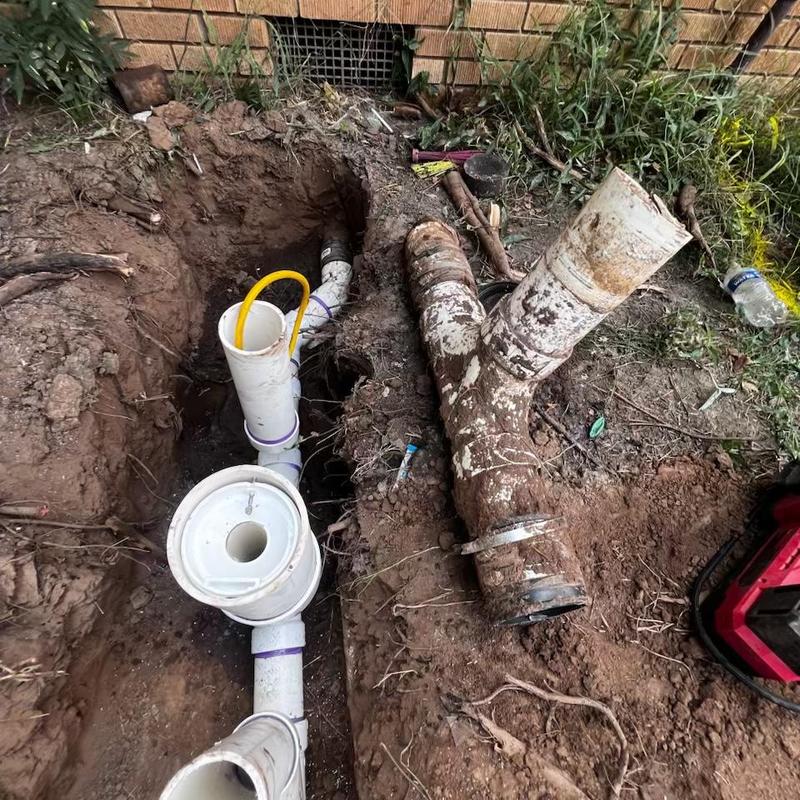 New sewer service line installation in dirt trench