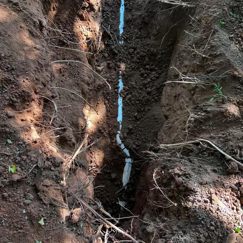 Sewer service line installed in trench with soil digging