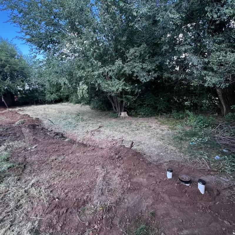 Sewer service line trench and pipe installation outdoors