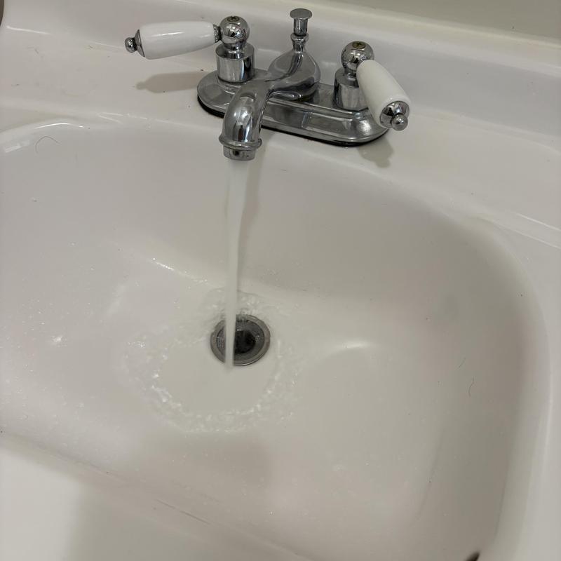 Bathroom sink drain clearing with cable tool