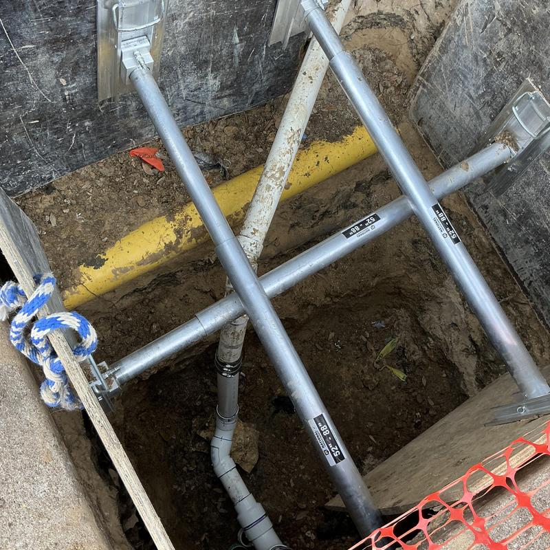 PVC sewer line with broken fittings in trench