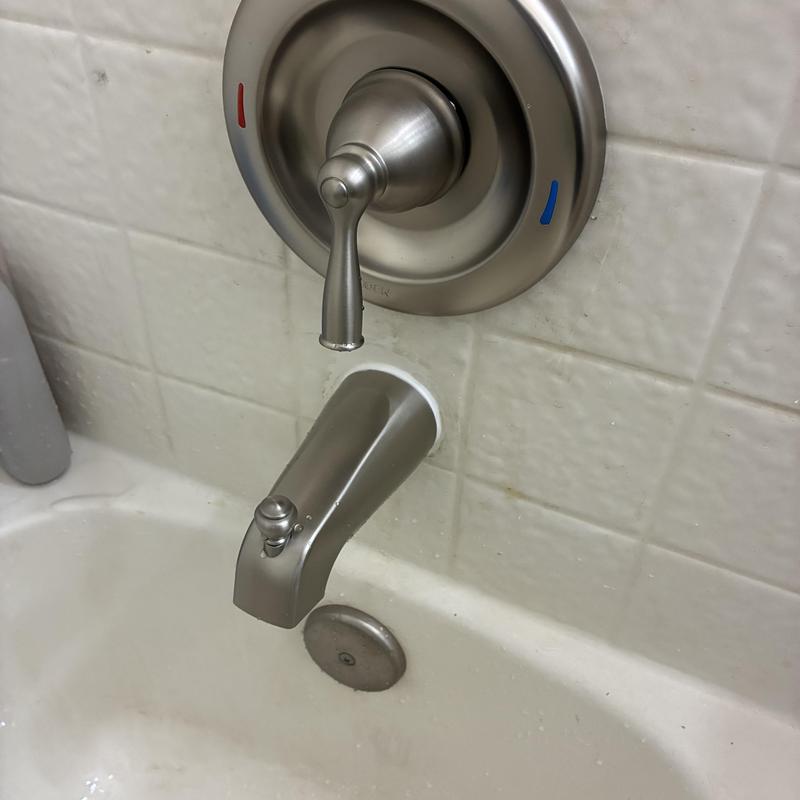 Bathtub faucet and handle with tiled wall
