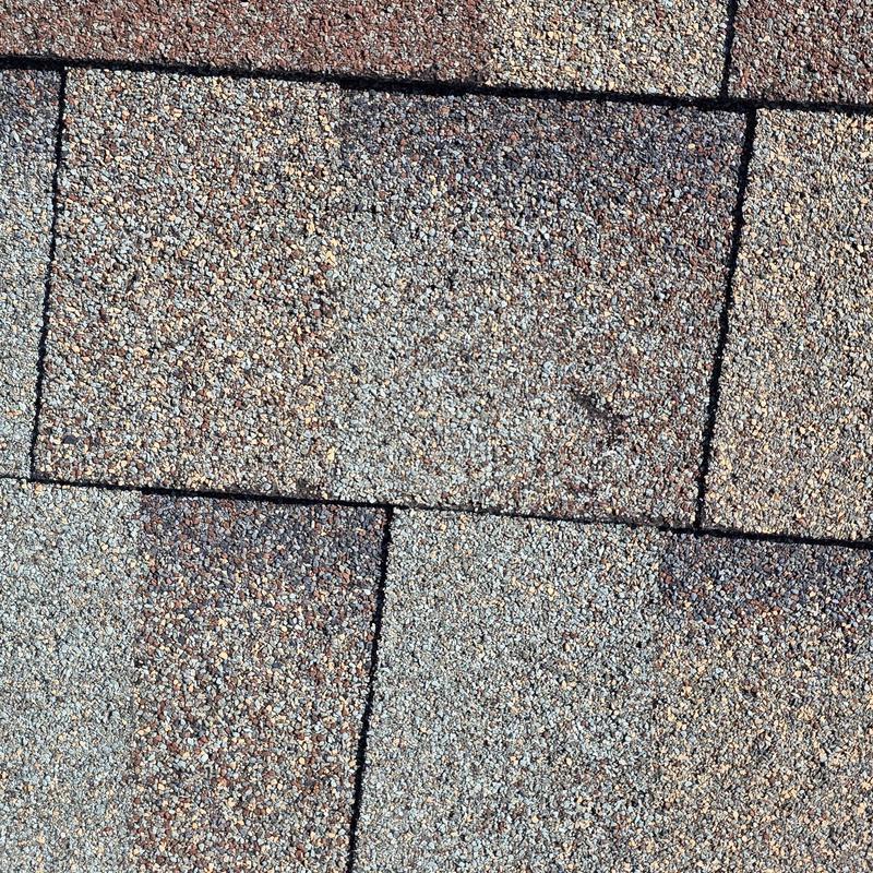 Asphalt roof shingles with hail damage close-up