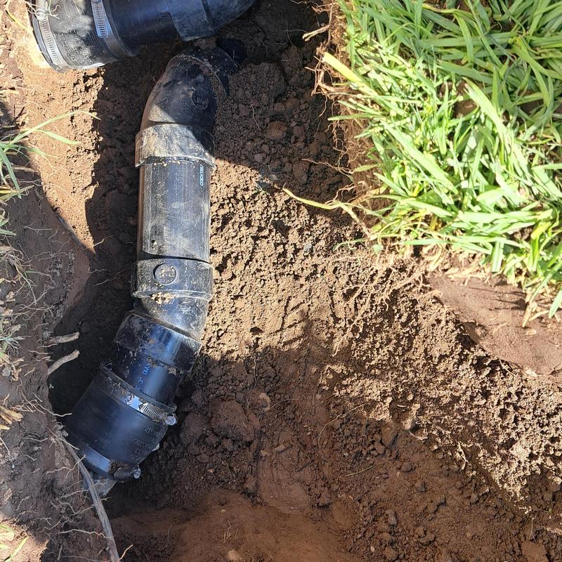 Sewer ejector pump pipe in yard trench