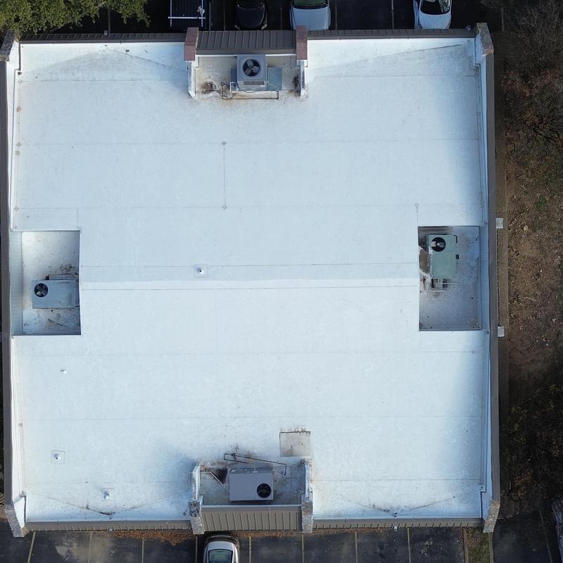 TPO membrane commercial roof with HVAC units viewed aerially