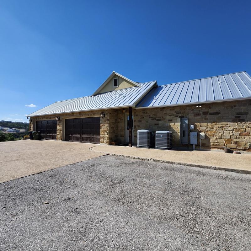 Standing seam metal roof with chimney chase cover and gutters Standing seam metal roof with chimney chase cover and gutters