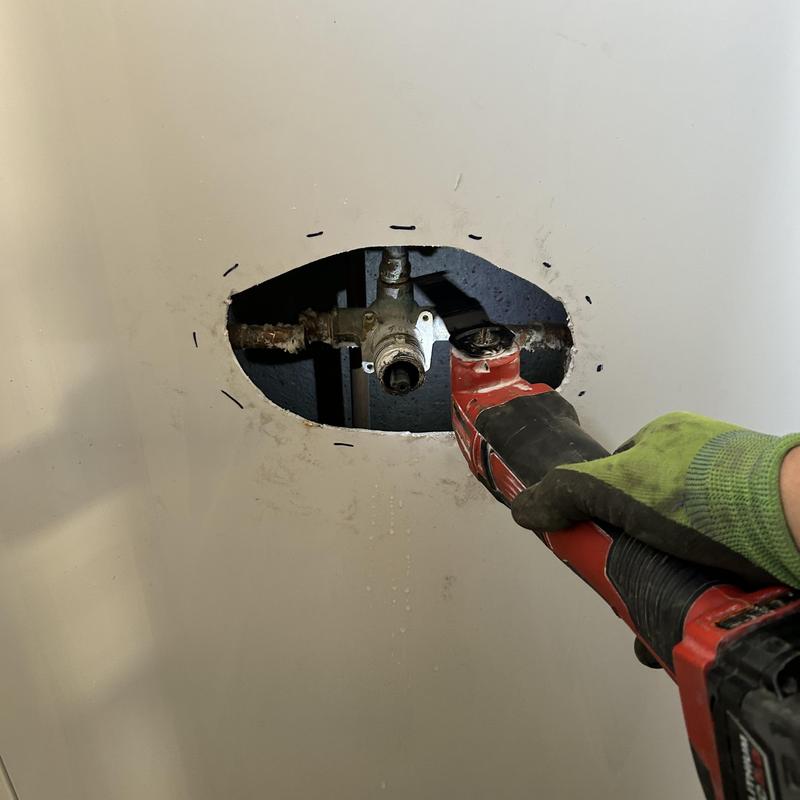 Shower valve replacement cutting access hole in wall