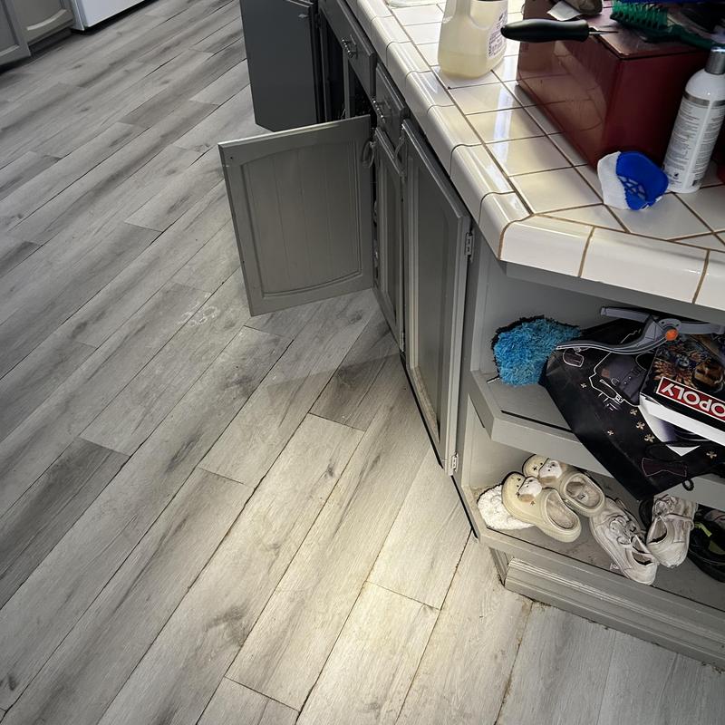 Kitchen cabinet with open doors and clutter inside