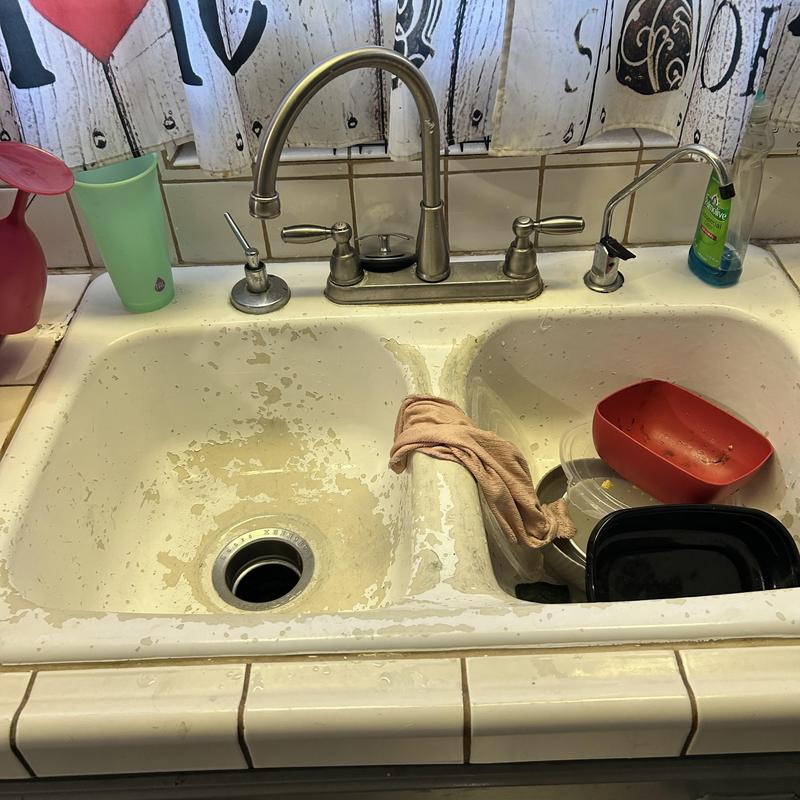 Kitchen sink with dual faucets and dishware