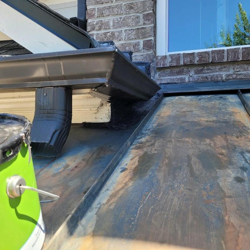 Metal roof patching near gutter and brick wall