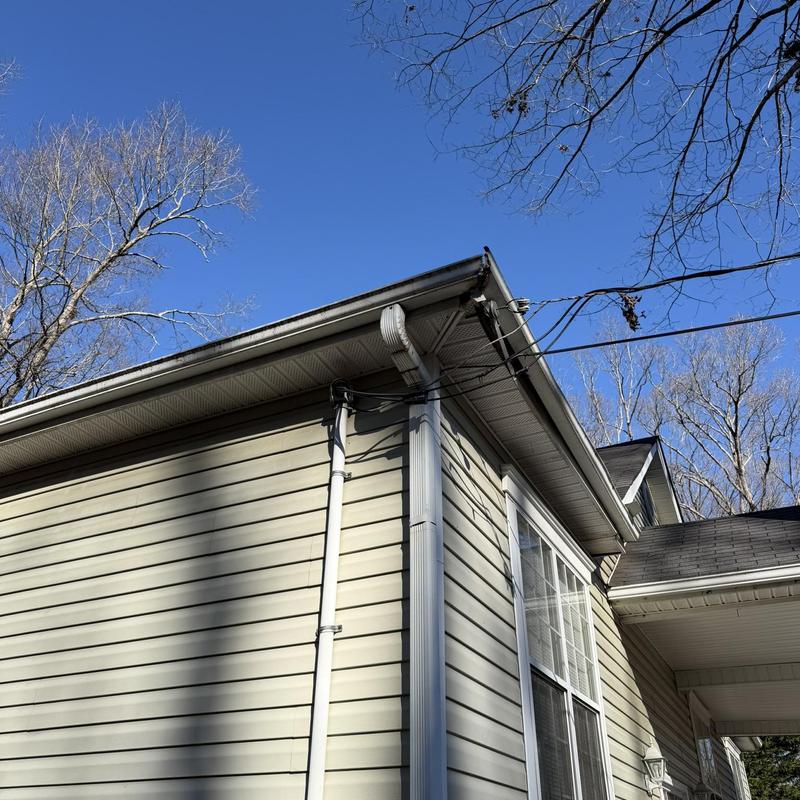 Metal gutter and fascia installation on house corner