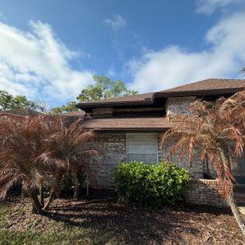 6 K style gutter along brick house roofline in daylight