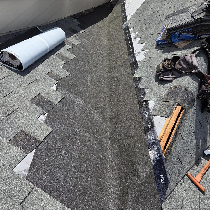 Roof valley underlayment installation with surrounding shingles