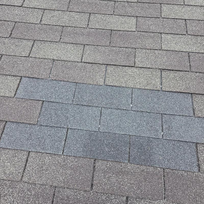 Roof shingles with patch of new shingles