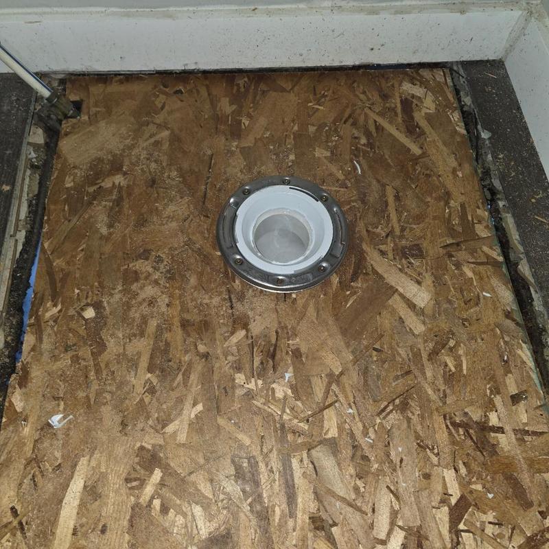 Toilet flange installed on rebuilt subfloor panel