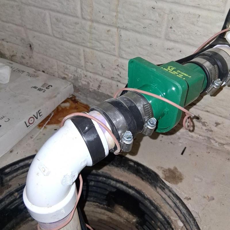 Sump pump discharge pipe with couplings and clamps