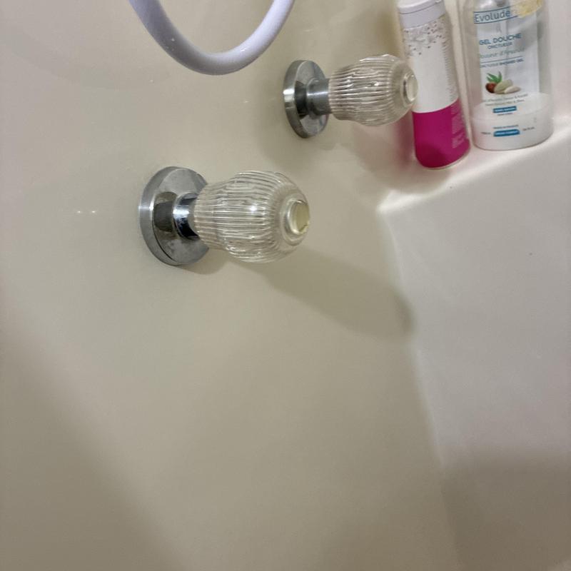 Shower valve knobs and bathtub fixtures close-up