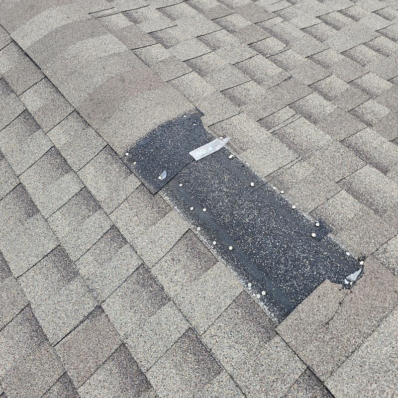 Asphalt shingle roof with hail damage and nail caps