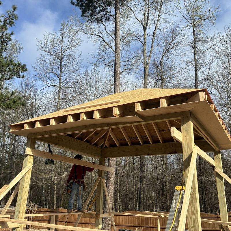 Screened enclosure framing with roof under construction
