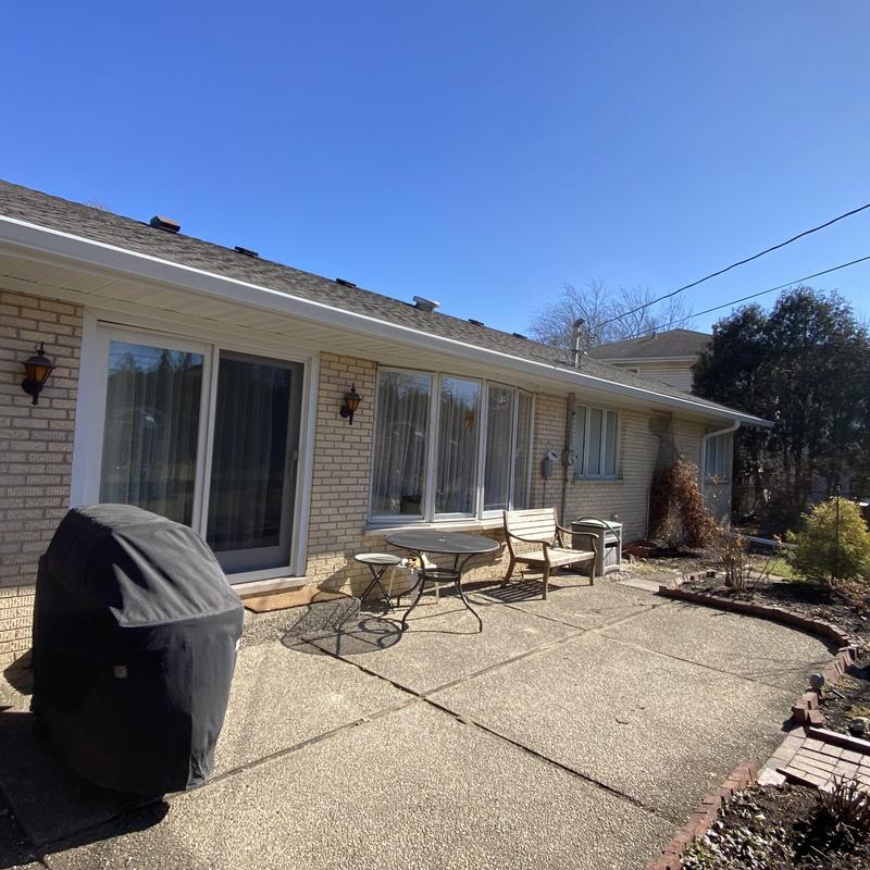 Gutters and soffit with fascia on brick house exterior