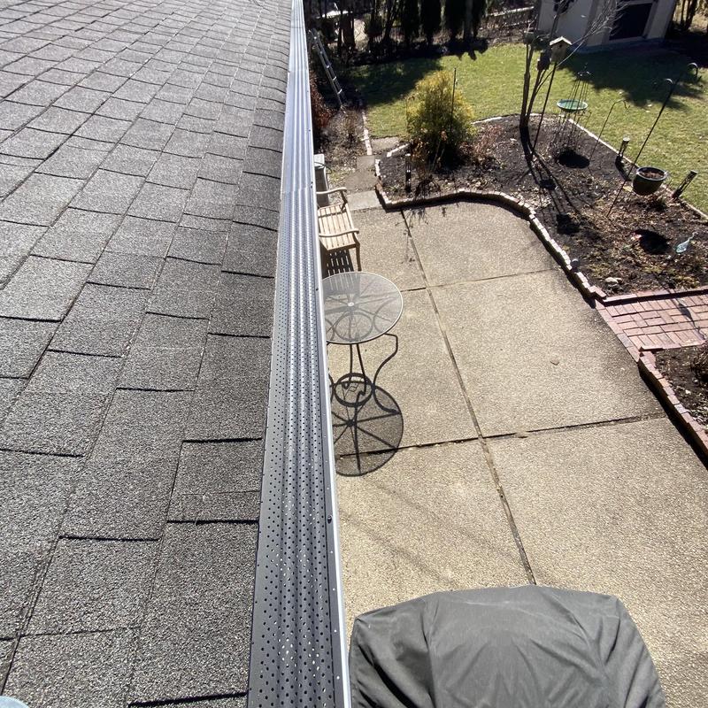 Gutter guards installed on residential roof edge