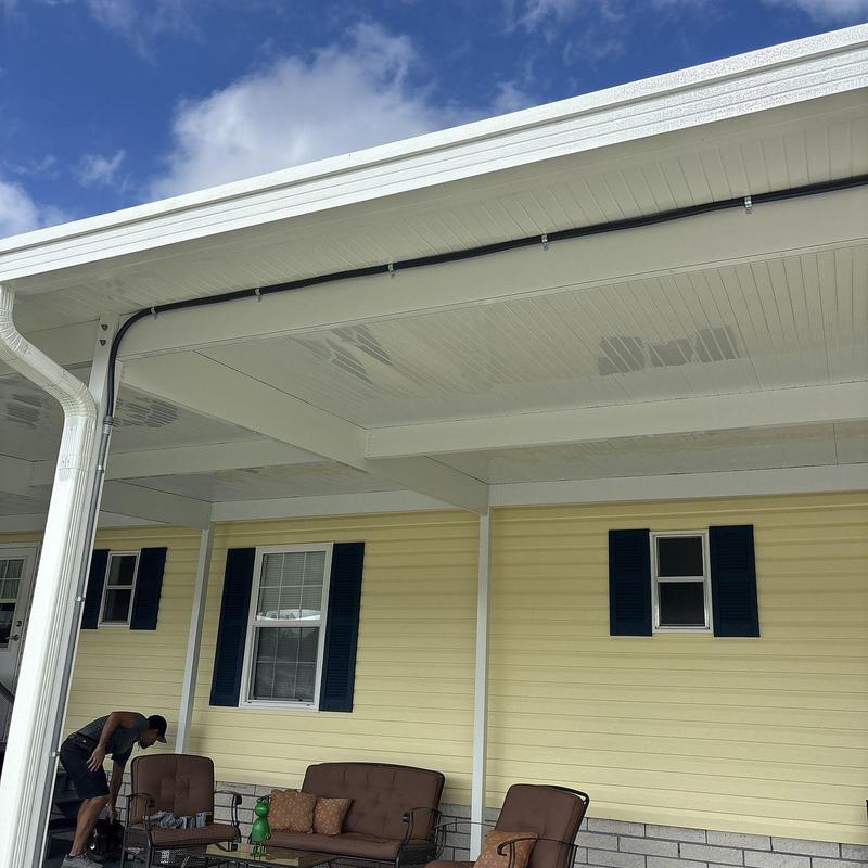 Vinyl siding and custom pergola on home exterior