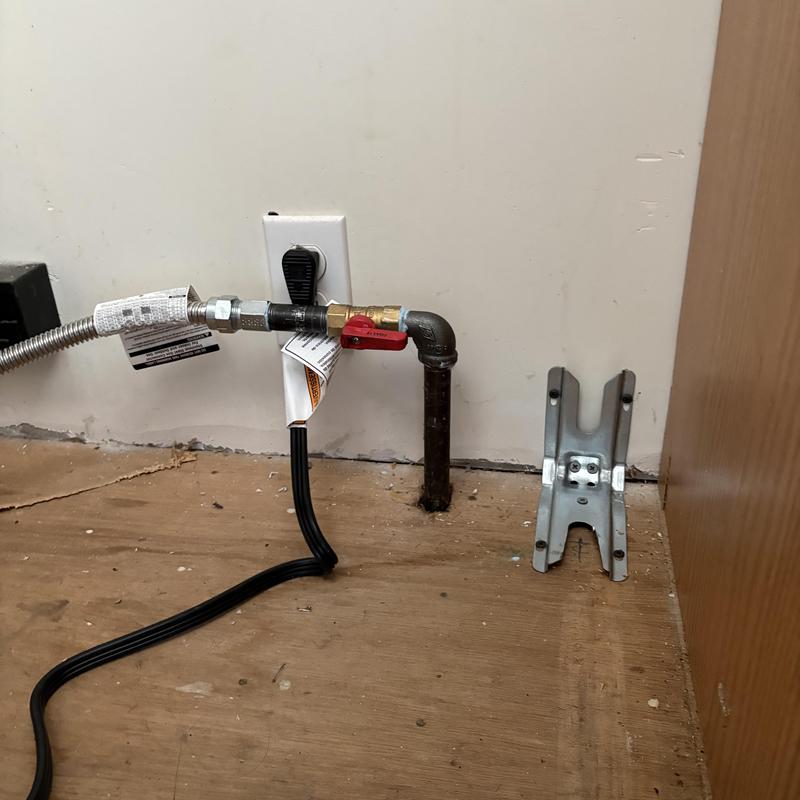 Gas stove supply line with valve and elbow on floor Gas stove supply line with valve and elbow on floor