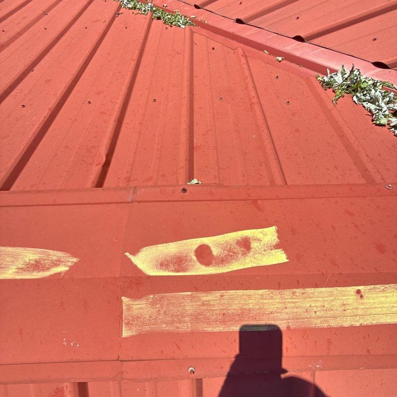 Metal roof panels with hail damage markings