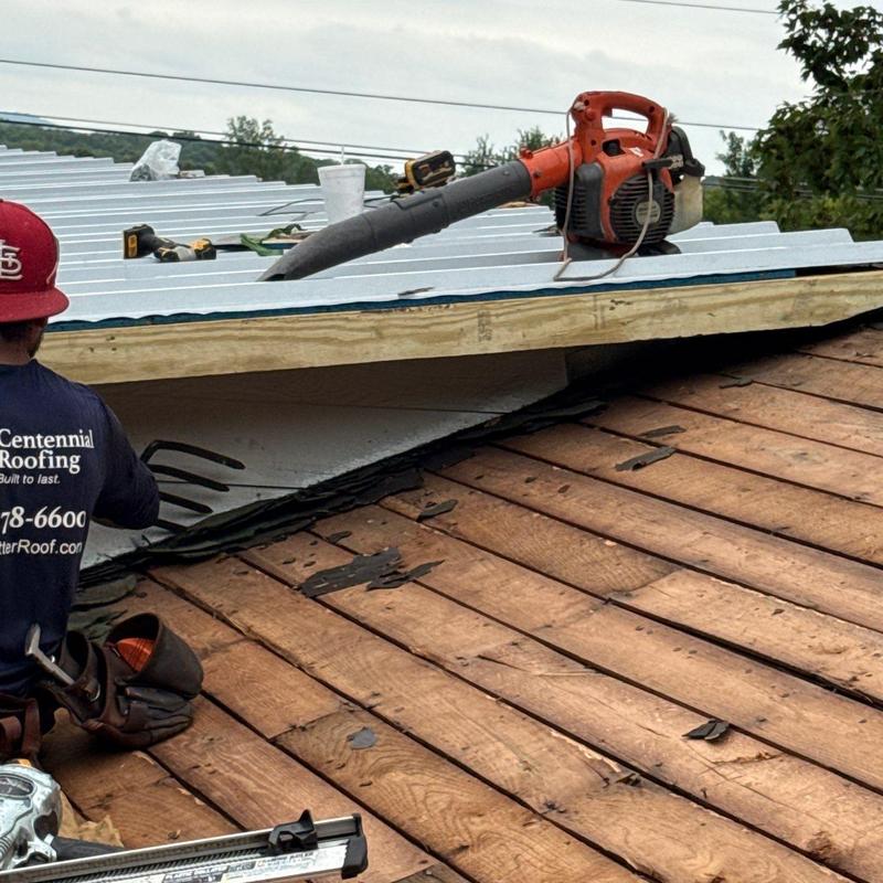 Metal roofing panel installation with roofing tools on roof
