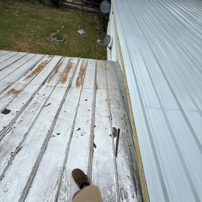 Metal roof panels with rust and debris buildup