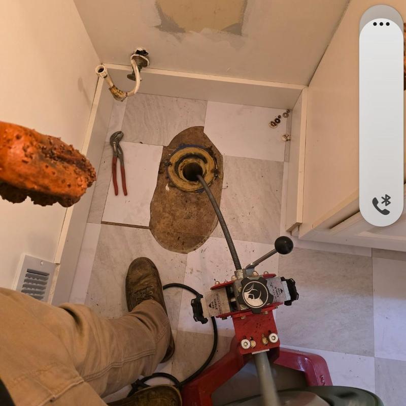 Toilet flange with drain cable clearing blockage