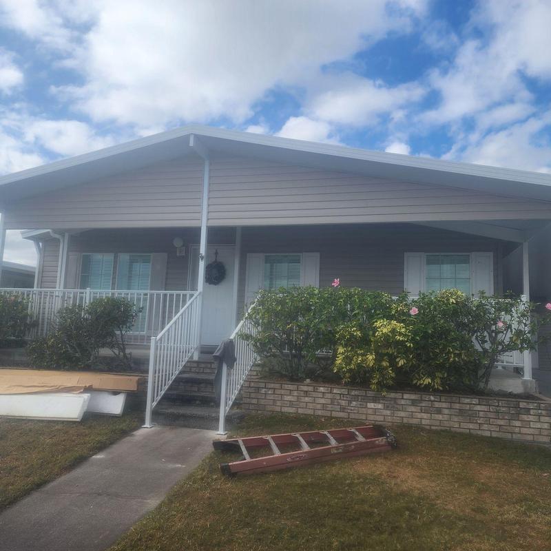 Lanai with attached carport and white railing
