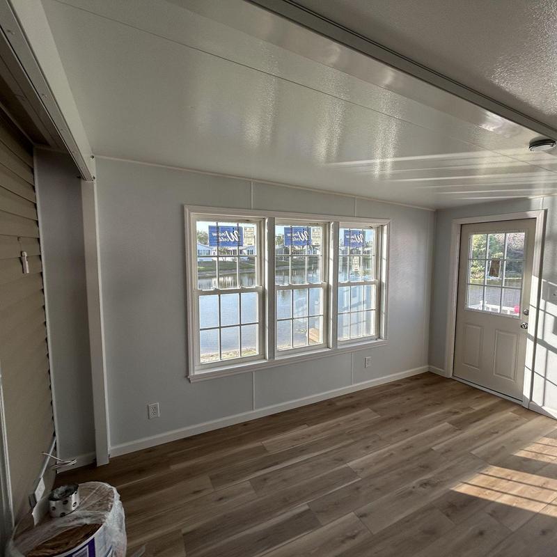 Lanai interior with windows and door, wood flooring