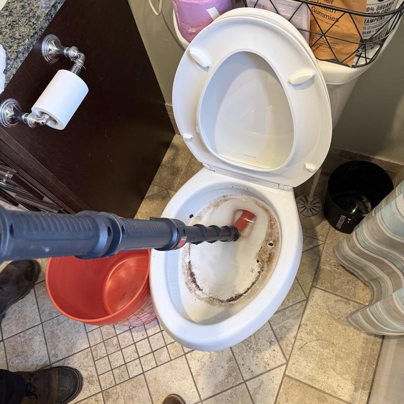 Toilet bowl clog removal with power auger tool Toilet bowl clog removal with power auger tool