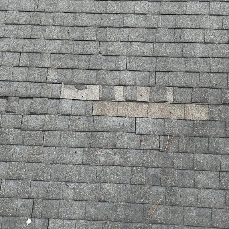 Asphalt shingles with missing and damaged pieces
