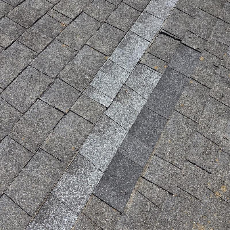 Roof shingles with replaced flashing strip