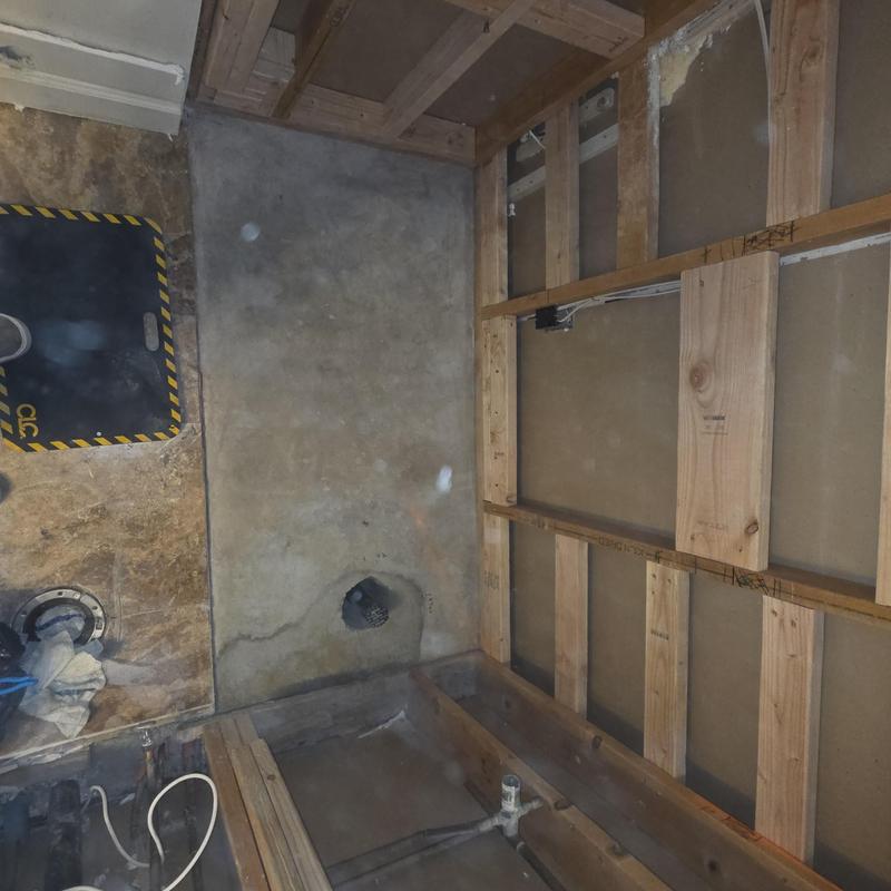 Shower pan concrete base with exposed wood framing