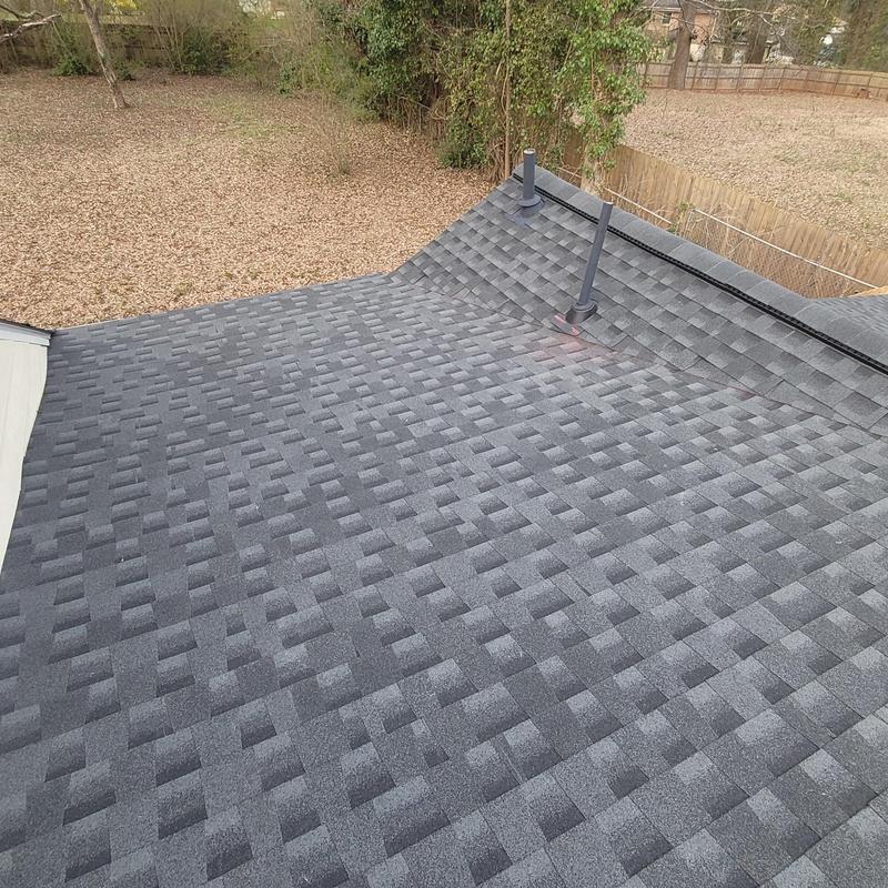 Asphalt shingle roof with vent pipes and curb flashing