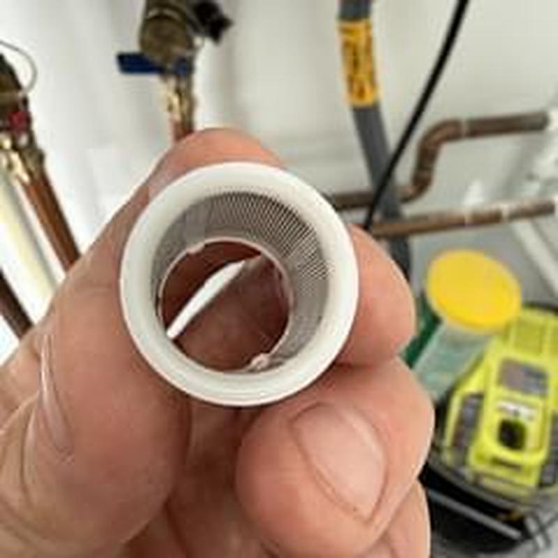 Tankless water heater filter screen close-up inspection