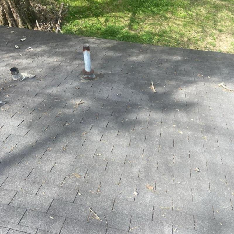 3 tab shingle roof with vent pipes and debris