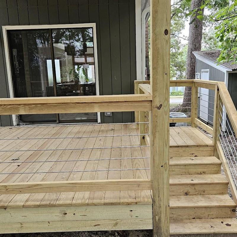 Wooden deck with cable railing and stairs installation Wooden deck with cable railing and stairs installation