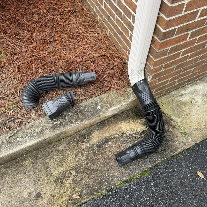 Gutter downspout extension replacement on brick corner
