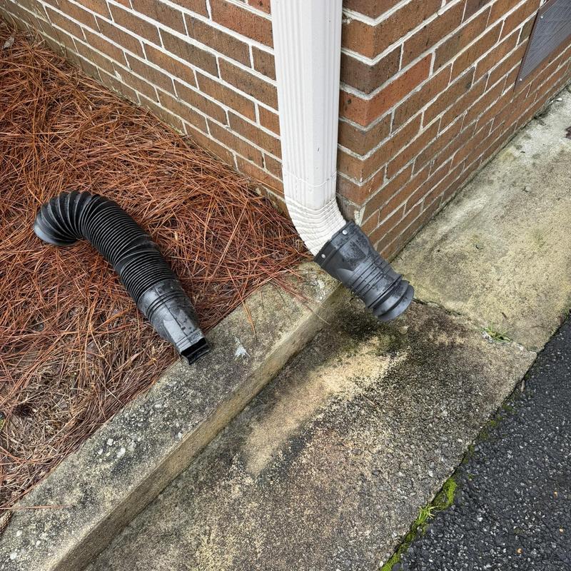 Gutter downspout extension replacement at brick corner