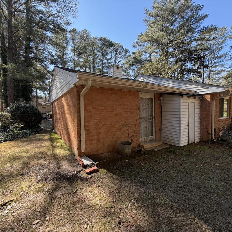 Downspout on rear brick wall of house exterior