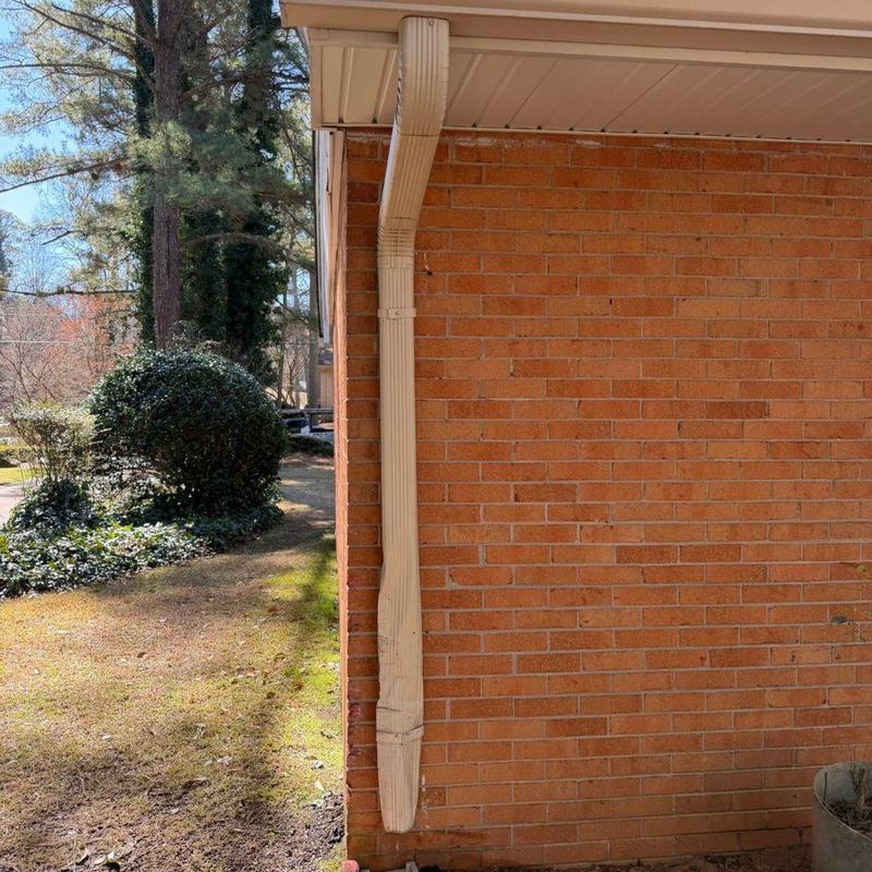 Downspout on right rear side of brick house