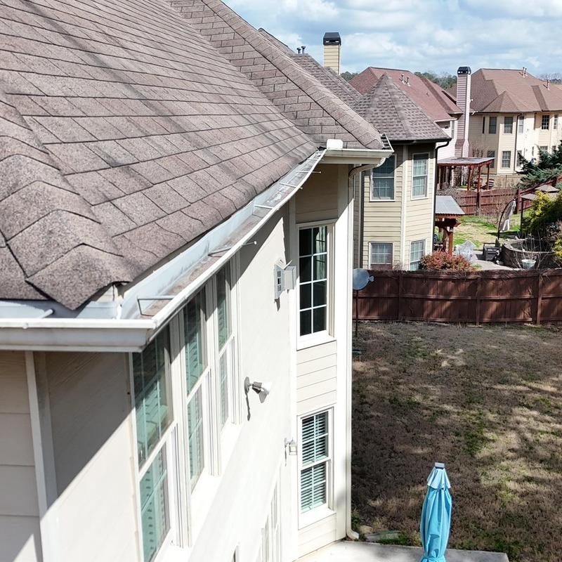 Roof shingles and gutter section replacement on house rear