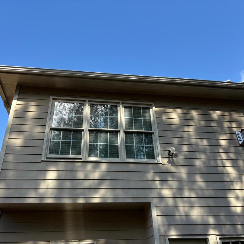 Rear gutters on house with siding and window above