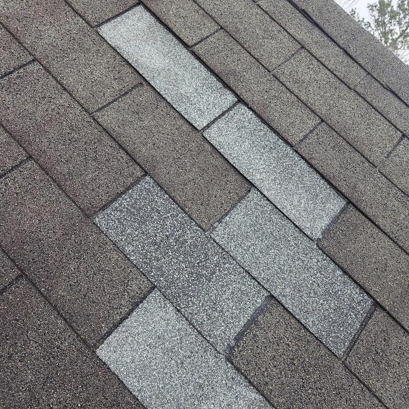 Roof shingles with several replacements on asphalt roof