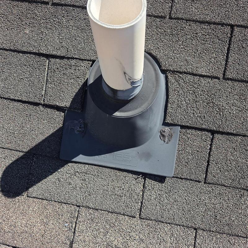 Roof pipe flashing on asphalt shingle roof