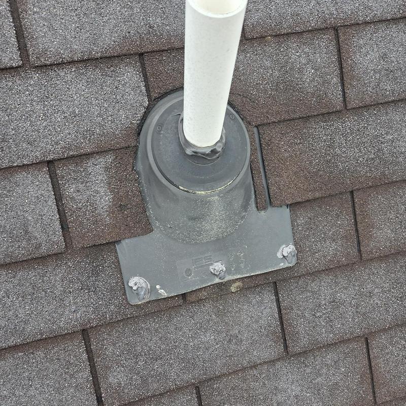 Plumbing vent pipe flashing on shingle roof